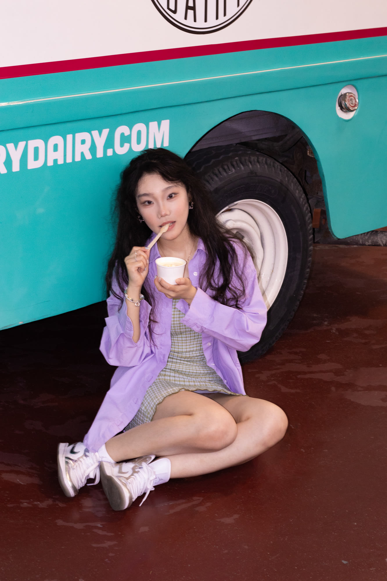 Colourful personal portrait seated in the doorway of a retro dairy truck