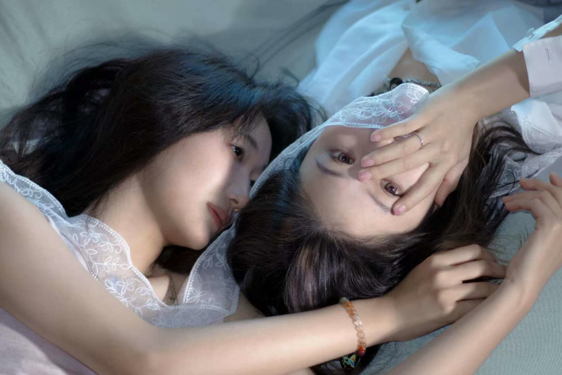 Sapphic couple photographed together in soft window light